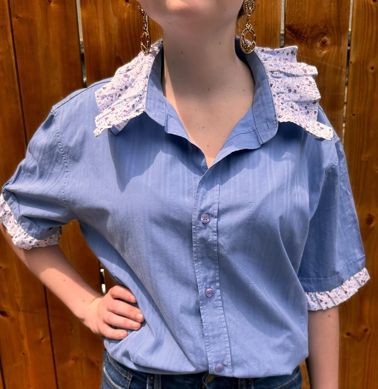 Soft blue short-sleeve shirt with a floral ruffle collar and cuffs